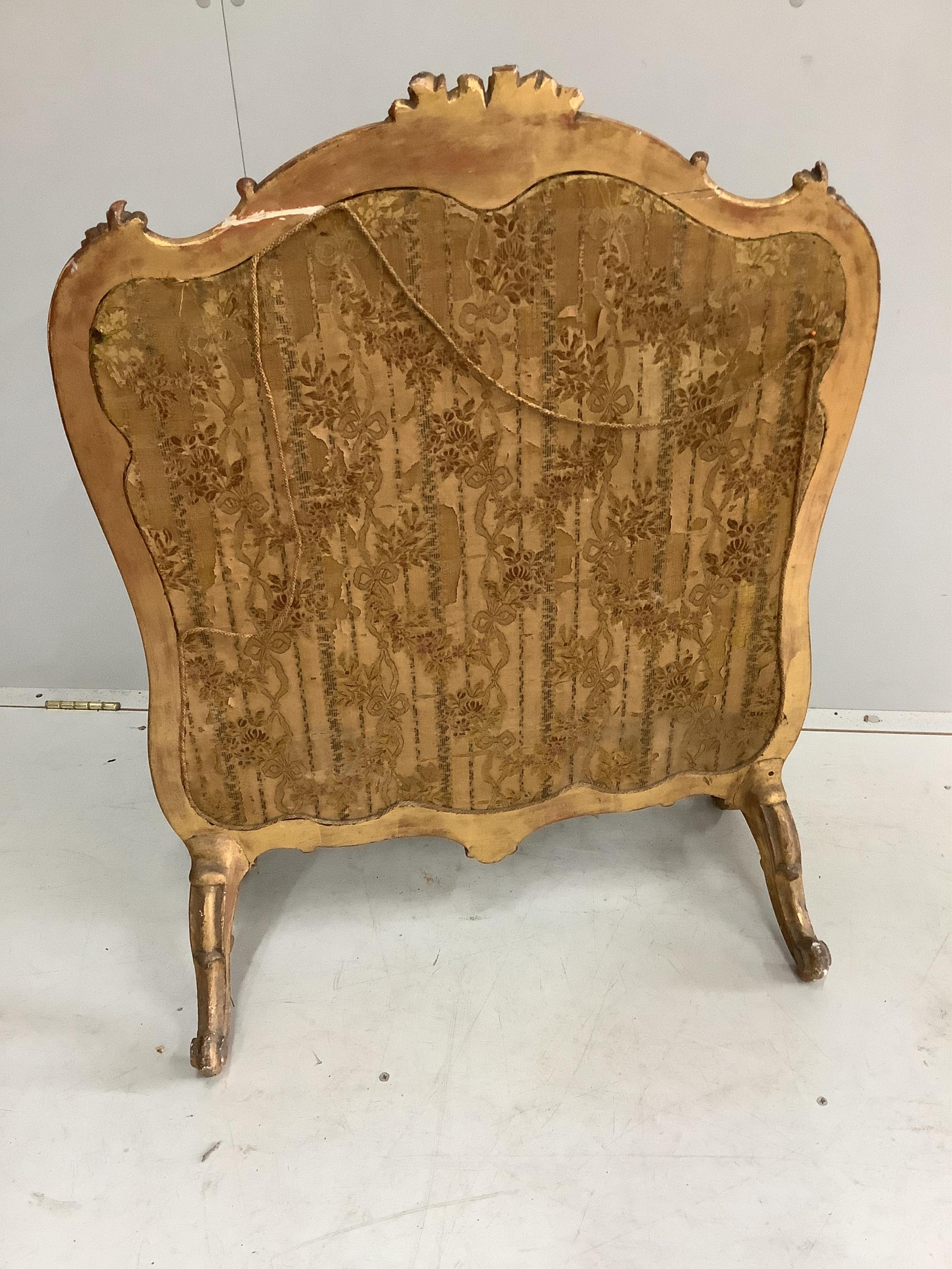 A Victorian giltwood and composition firescreen, inset silk thread embroidered panel, width 69cm, height 90cm. Condition - fair